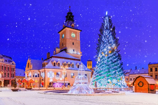 Brasov, Romania. Old Town Christmas Market at twilight with snow effect.