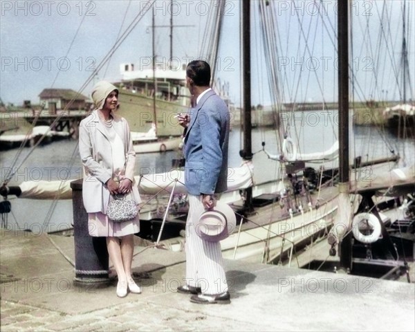 1920s WELL DRESSED STYLISH COUPLE STANDING TALKING TOGETHER MAN SMOKING CIGARETTE YACHT MARINA DEAUVILLE FRANCE  - y1064c HAR001 HARS NOSTALGIA OLD FASHION 1 STYLE FRANCE VACATION YACHT JOY LIFESTYLE HISTORY CELEBRATION FEMALES MARRIED SPOUSE HUSBANDS HEALTHINESS LUXURY COPY SPACE FRIENDSHIP FULL-LENGTH LADIES PERSONS MALES PARTNER SUMMERTIME RESORT TIME OFF DREAMS HAPPINESS ADVENTURE DISCOVERY STYLES TRIP GETAWAY RECREATION SEASIDE CLOCHE WELL DRESSED HOLIDAYS REGION NORTHWESTERN CONCEPTUAL SPORT JACKET SAIL BOAT STYLISH NORMANDY FASHIONS MID-ADULT MID-ADULT MAN MID-ADULT WOMAN PANAMA HAT