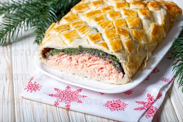Homemade Salmon Wellington. It is made from Salmon Fish, spinach, mushrooms, spices, herbs and puff pastry. Copy space