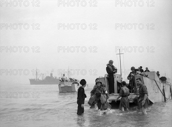 Troops and ammunition being brought ashore from LCAs (landing craft assault) at Arzeau in Algeria during Operation 'Torch', November 1942. Troops and ammunition for light guns being brought ashore from a landing craft assault (ramped) (LCA 428) on Arzeau beach, Algeria, North Africa, whilst another LCA (LCA 287) approaches the beach.