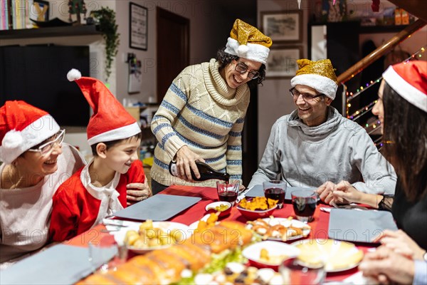 Happy family having fun at christmas dinner table