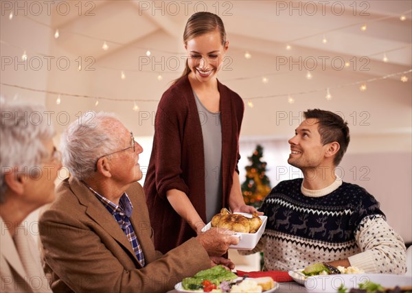 Christmas dinner with the family. A happy family sitting around the dinner table on Christmas day.