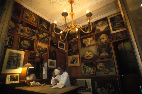 Mr Poilane drinking coffee in his office paris