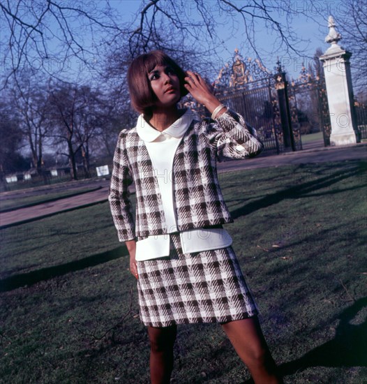 Lady in business suit in the park 1960s