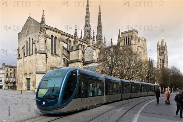 Modern tram in front of St Andre Cathedral and Pey Berland Tower in the city centre, Bordeaux, Aquitaine, France