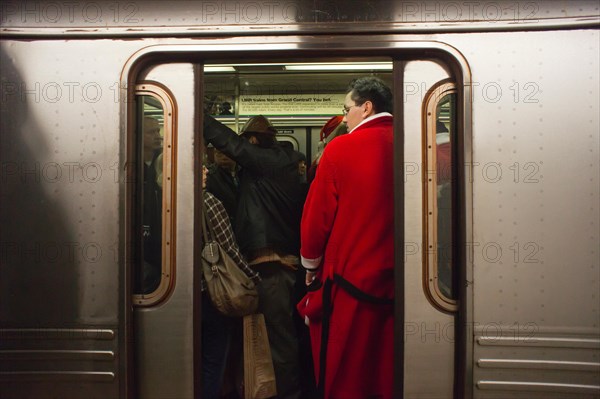 Christmas revelers participating in the annual Santacon travel on the subway in New York on Saturday, December 10, 2011. Santacon, primarily a pub crawl in Santa and other Christmas related costumes, attracts hundreds of masqueraders going from bar to bar. The drinkers were encouraged to imbibe at e