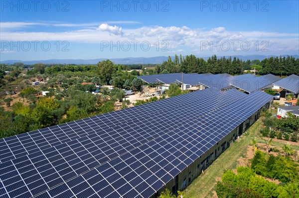 Solar panels at a farm on commercial greenhouses, aerial view, Roquebrune-sur-Argens, Var region, South of France, Europe