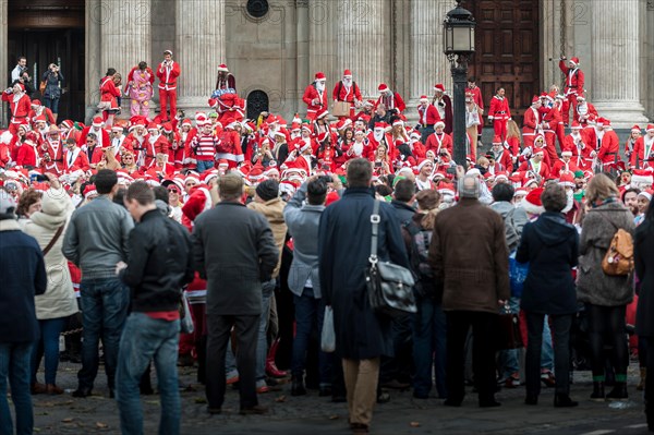 London, UK. 14th December, 2013.  Hundreds of Santas gathering on the steps of St Pauls Cathedral before they march off to meet up with groups of other Santas to celebrate the annual Santacon.  Photographer: Gordon Scammell/Alamy Live News