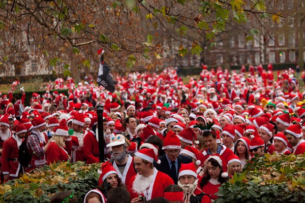 London, UK. 14th of December 2013 Annual Santa Con gathering hits Central London. Every year in December thousands of people dress up as Santa for the annual get together of Santa Con, they walk from various landmarks in London. Credit:  nelson pereira/Alamy Live News