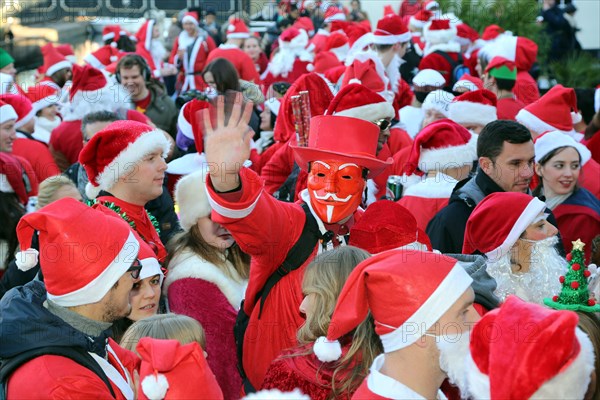 London, UK. 6th December 2014. Participants dressed as Father Christmas in the 2014 London Santacon in the streets of Camden, London which celebrates its 20th anniversdary this year Credit:  Paul Brown/Alamy Live News