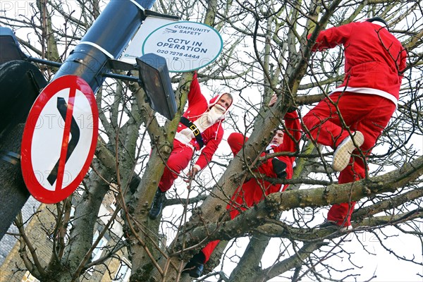 London, UK. 6th December 2014. Participants dressed as Father Christmas in the 2014 London Santacon in the streets of Camden, London which celebrates its 20th anniversdary this year Credit:  Paul Brown/Alamy Live News