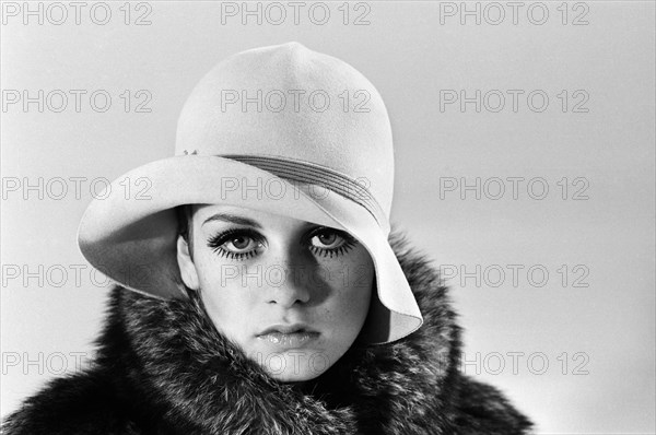 Model Twiggy posing in the studio wearing a hat. December 1966.