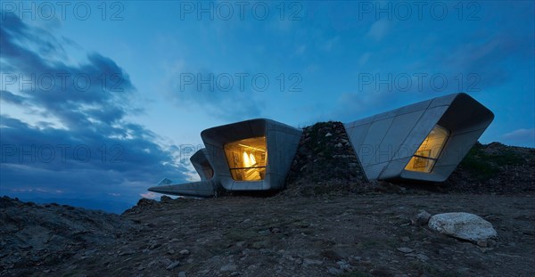 View towards picture windows at dusk. Messner Mountain Museum Corones, Mount Kronplatz, Italy. Architect: Zaha Hadid Architects,