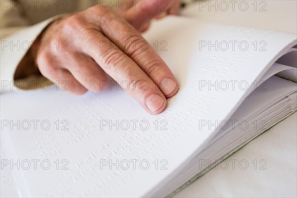 Senior woman using braille to read