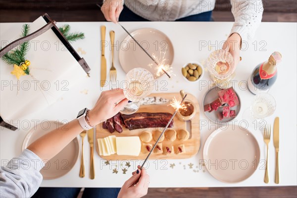 Christmas Family Dinner Table Concept. Christmas feast. Holiday Gold place setting, overhead shoot