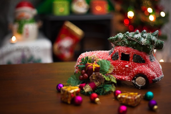 Christmas decoration background with Christmas tree on red car. Add your own text.