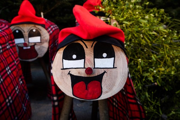 some handmade tio de nadal, a typical christmas character of catalonia, spain, on sale in a christmas market