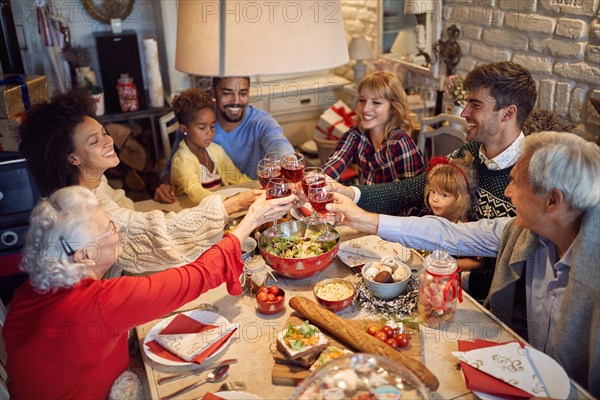 large happy family clinking glasses on Christmas dinner