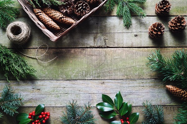 Christmas decoration using fresh and all natural materials on wooden table.