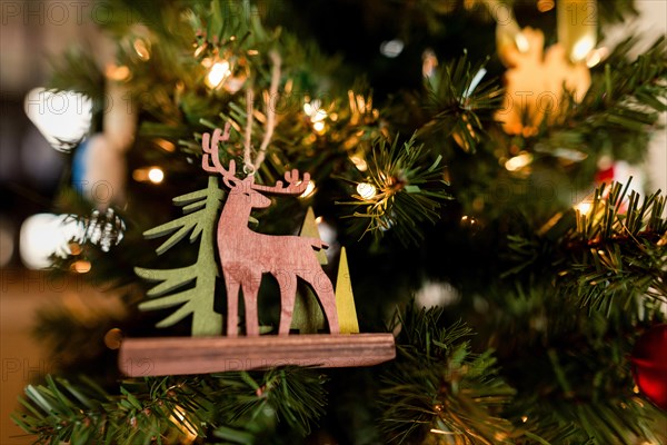 Reindeer decoration on Christmas tree at home