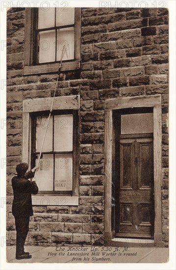 Early 1900's postcard of Knocker Up man, known as the Knocker upper, (before alarm clocks) in Accrington, Lancashire, England, U.K. posted September 1918. The Knocker Upper woke up the mill workers in mill towns.