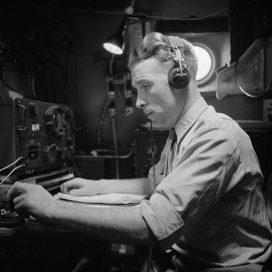 War Volunteers in Malacca and Indonesia Description: The first telegraphist in the Skymaster 313 with Van de Poll aboard at Bangkok Date: February 1946 Location: Thailand Keywords: telegraphs, aircraft