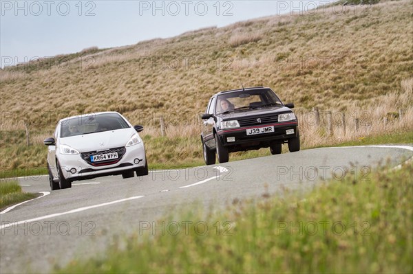 A Peugeot 205 GTI and Peugeot 208 GTi during a photoshoot in Wales featuring the 205 GTI and the 208 GTi, 29th June 2015