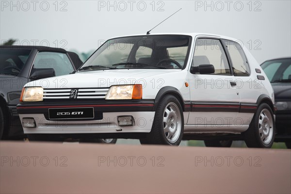 Cobreces, Spain - August 14, 2021: Car show in Cobreces. Original white Peugeot 205 GTI. The Peugeot 205 is a car produced by the French manufacturer