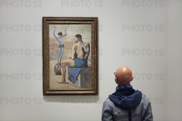 Visitor in front of the painting 'Young Acrobat on a Ball' by Pablo Picasso (1905) displayed at the exhibition 'Icons of Modern Art from the Morozov Collection' in the Fondation Louis Vuitton in Paris, France. The exhibition runs till 22 February 2022.