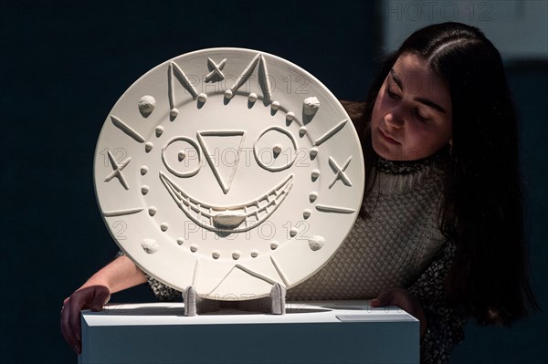 London, UK.  16 May 2022. A staff member views “Horloge à la langue”, 1956, by Pablo Picasso (Est. £5,000 - £7,000) at a preview of Bonhams’ Picassomania sale at Bonham’s New Bond Street galleries.  Artworks made by Pablo Picasso from prints to ceramics, works on paper to photographs will be auctioned on 18 May 2022. Credit: Stephen Chung / Alamy Live News