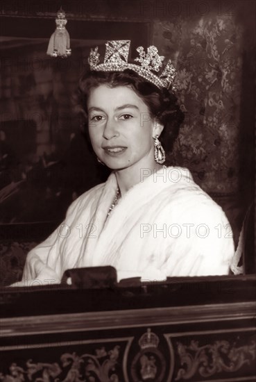 Queen Elizabeth II in the Irish State coach en route from Buckingham Palace to Parliament for the State Opening of Parliament on November 5, 1957.