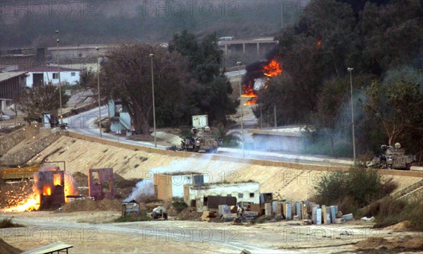 Iraq War April 2003 The opening shots in The Battle for the Republican Palace fall short into the grounds of the Palace in Baghdad Our Picture Shows American armoured vehicles firing on Iraqi positions