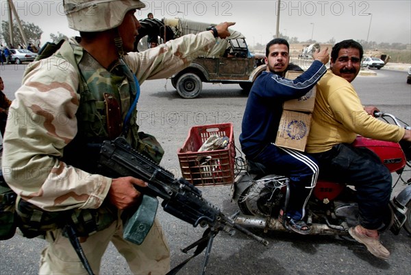 Iraq War April 2003 Baghdad American marines take postions in Eastern Baghdad whilst liberating the city Our Picture Shows American GI s trying to prevent local iraqi s from looting