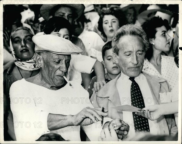 Aug. 08, 1955 - Picasso At Bullfight: Photo Shows The famous artist Picasso wearing cap, signs autographs, when he was a spectators at the bull fight he organized at Vallauris, near Cannes, South of France.Next to him is Jean Cocteau, the playwright.