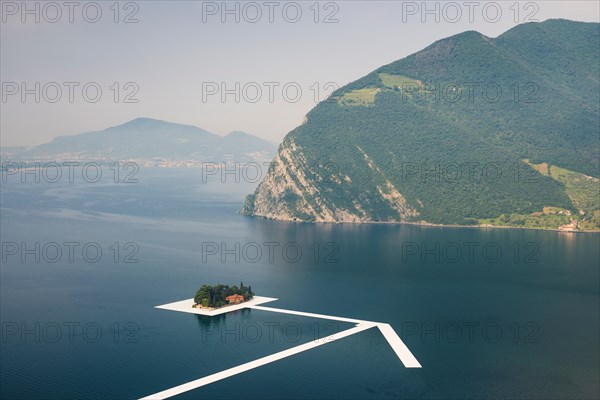 Swimming pontons form a giant arrow at Saint Paul island for Christo's project 'The floating piers' on Lake Iseo, Italy
