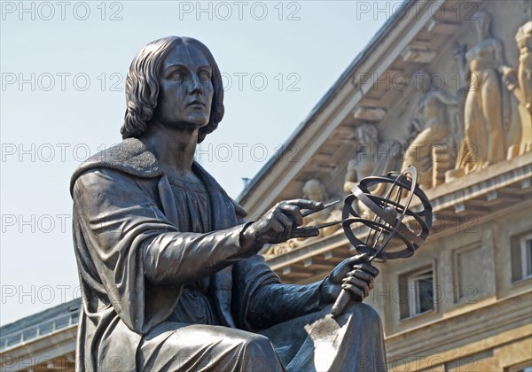 the Polish astronomer Nicolaus Copernicus, holds a compass and armillary sphere,  Warsaw, Poland.