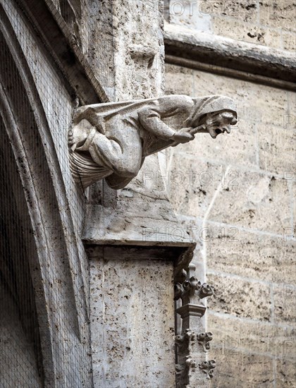 Gargoyle like medieval witch on wall of Rathaus or New Town Hall on Marienplatz Square, Munich, Bavaria, Germany. This building is landmark of Munich.