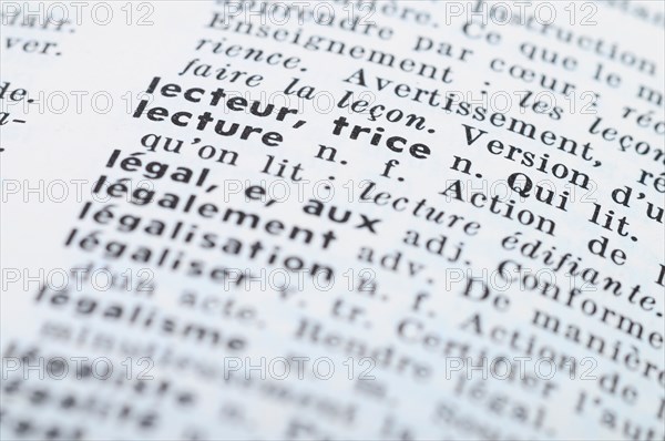 Close up of french dictionary at the word Reading
