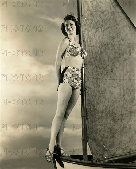 The American actress Frances Rafferty in a bathing suit on a small sailboat