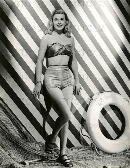 A model wears a swimsuit two-piece 40s