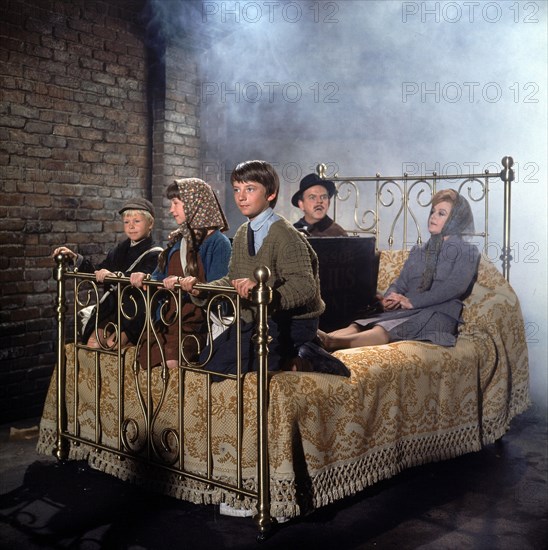 RELEASE DATE: December 13, 1971. MOVIE TITLE: Bedknobs and Broomsticks. STUDIO: Walt Disney Pictures. PLOT: An apprentice witch, 3 kids and a cynical conman search for the missing component to a magic spell useful to the defence of Britain. PICTURED:  ANGELA LANSBURY as Eglantine Price and DAVID TOMLINSON as Mr. Emelius Browne.