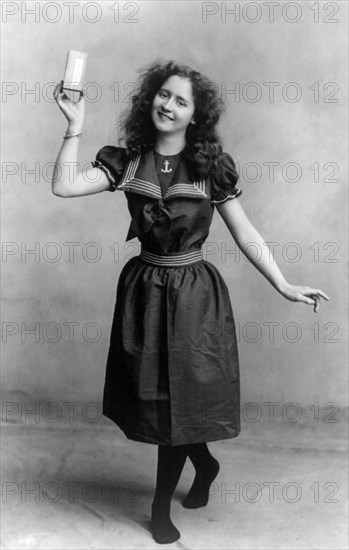 Young woman wearing turn-of-the-century bathing suit, posed holding unidentifiable product, 1901. By the end of the 19th century people were flocking to the oceanside beaches for popular seaside activities such as swimming, surf bathing, and diving. The c