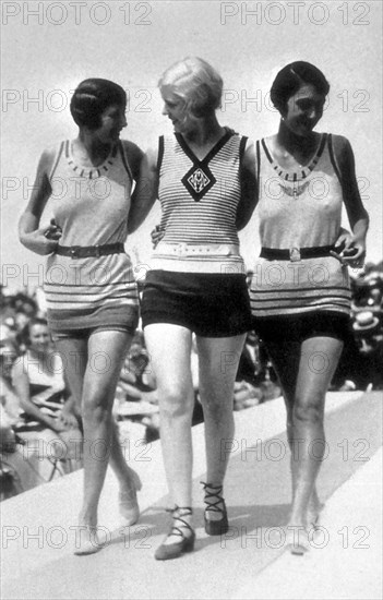 Entitled: "Swimwear on catwalk deauville France, 1928." Fashion is a distinctive and often habitual trend in the style in which a person dresses. It is the prevailing styles in behavior and the newest creations of textile designers. Prior to the mid-19th