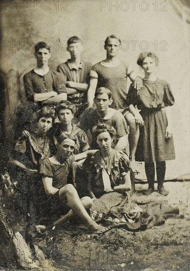 Group portrait of five men and five women (partly) in swimwear, standing and sitting in a studio setting, Anonymous