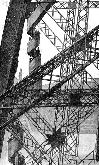 Workmen descending during construction of the Eiffel Tower between 1887 to 1889 as the entrance to the 1889 World's Fair, on the Champ de Mars in Paris, France. The wrought-iron lattice tower is named after the engineer Gustave Eiffel, whose company designed and built the tower. It was initially criticised by some of France's leading artists and intellectuals for its design, but it has become a global cultural icon of France and one of the most recognisable structures in the world.