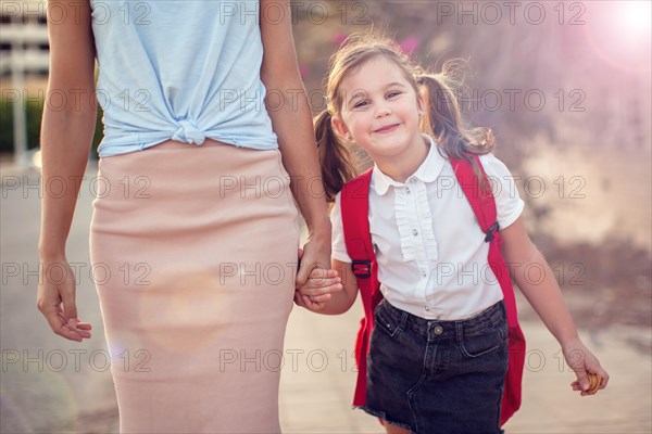 Back to school. Parent care concept. Pupil and mother going to school.