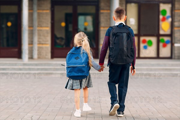 Two elementary students brother and little sister going back to school