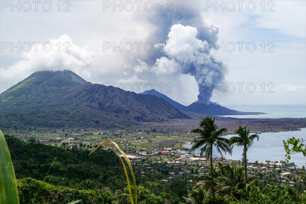 Looking across the town of Rabaul; Papua New Guinea toward the active Tavurvur volcano.