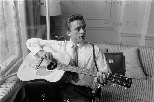 American country singer and musician Johnny Cash poses for photographers at the Savoy Hotel in London.17th September 1959.