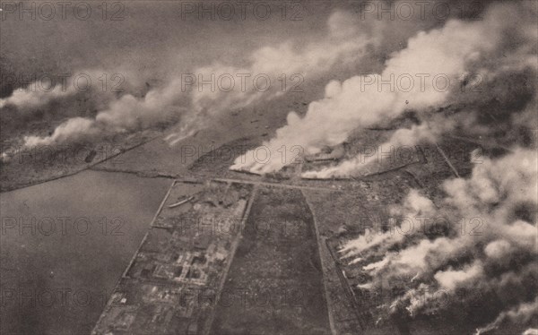 Japan Earthquake 1923: Tokyo ablaze : a horrible scene on the banks of the sumida river, as snapshot from on board a military aeroplane